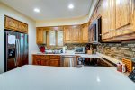 The fully stocked kitchen with ample counterspace is perfect for whipping up a gourmet meal.